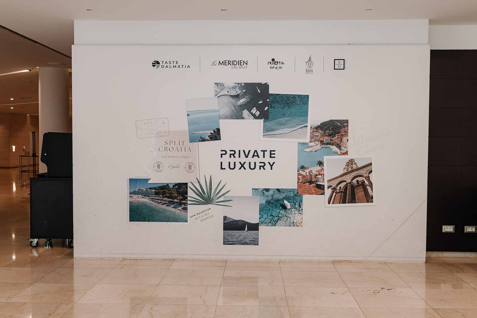 Wall wrapped in printed vinyl showing a "Private Luxury" photo collage of Dalmatian coast scenes and partner logos